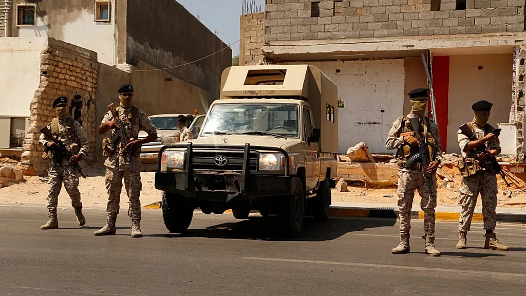 Armed men positioned in an urban area during a security operation in Zawiya, Libya
